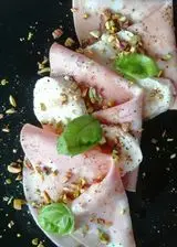 Ricetta Piatto di mortadella con mozzarella e granella di pistacchio.