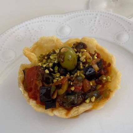 caponatina rivisitata con cappero caramellato su nido di parmigiano