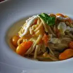 Ricetta Spaghettoni con datterini gialli, straccetti di burrata e basilico