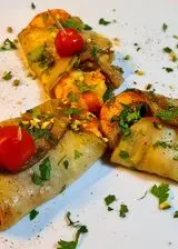 Ricetta Involtini di melanzane, gamberoni e granella di pistacchio.