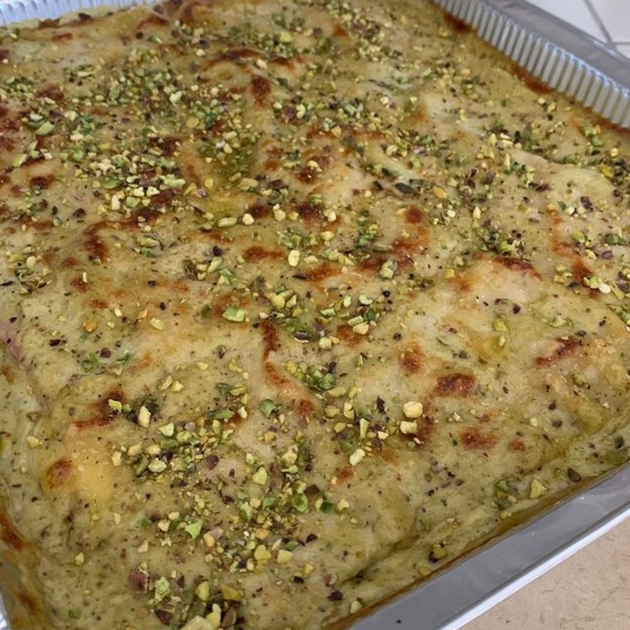 Lasagna al pesto di pistacchio, mortadella e provola