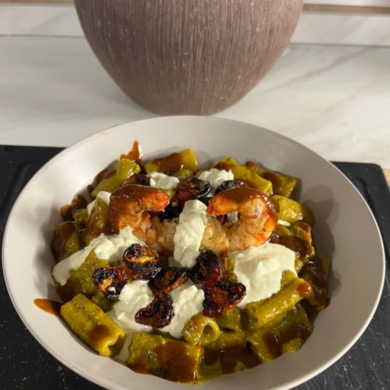 Pasta al pesto di fiori di zucca,gamberoni, pomodori confit e stracciatella