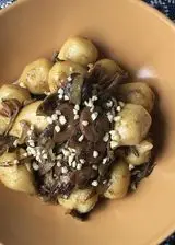 Ricetta Gnocchi ripieni di Asiago Dop e funghi porcini con carciofi, funghi e nocciole