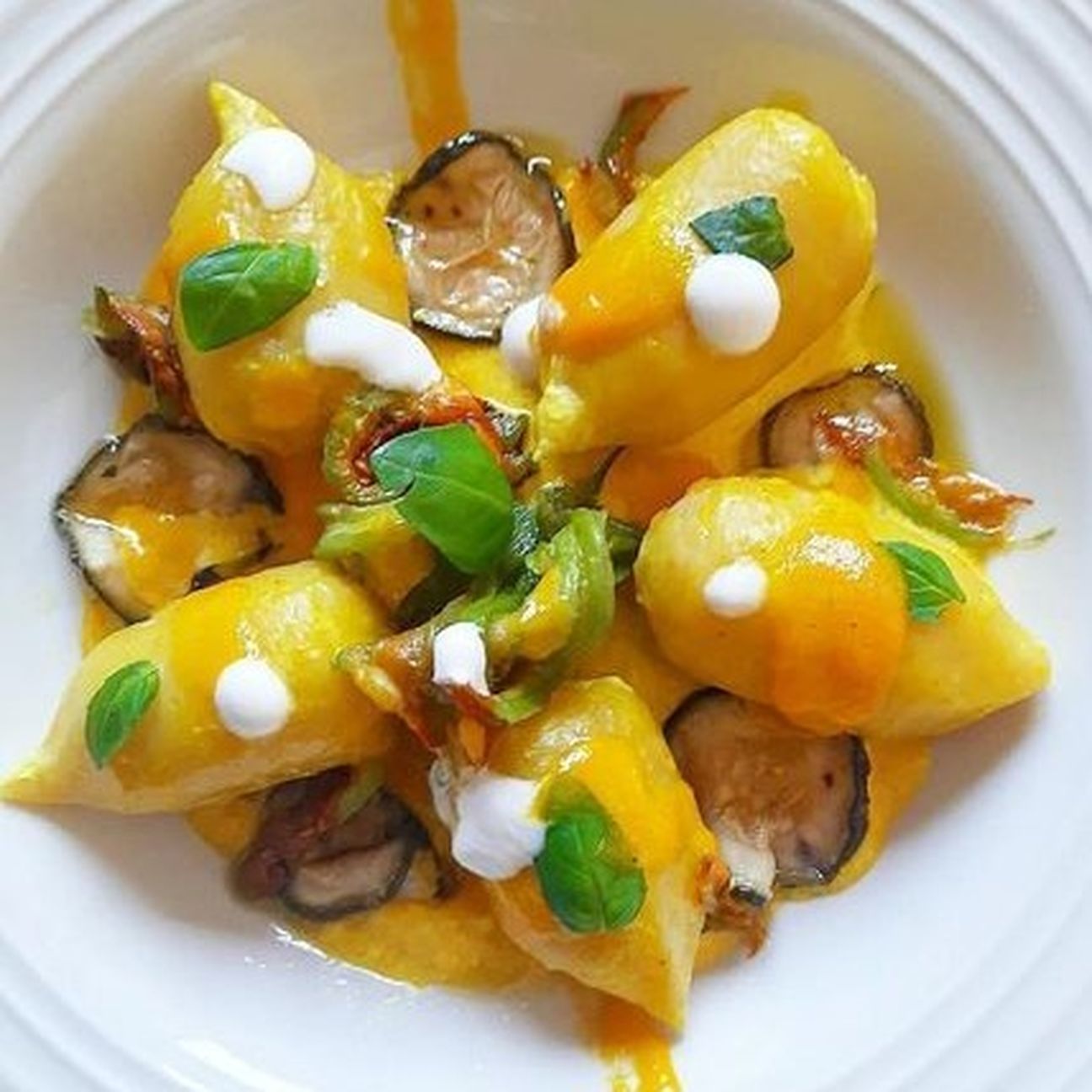 Gnocchi ripieni con pesto alla genovese, salsa di datterino giallo, fiori di zucca e ricotta