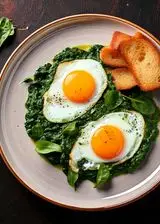 Ricetta Uova occhio di bue con spinaci e pane croccante