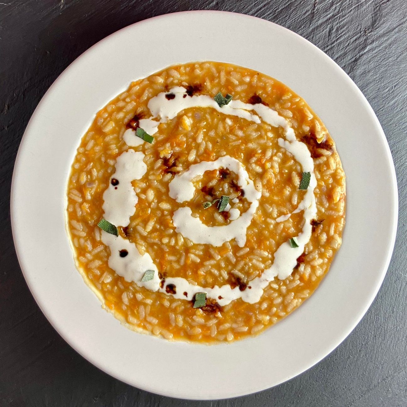 Risotto con Zucca, Crema di Pecorino e Aceto Balsamico Invecchiato.