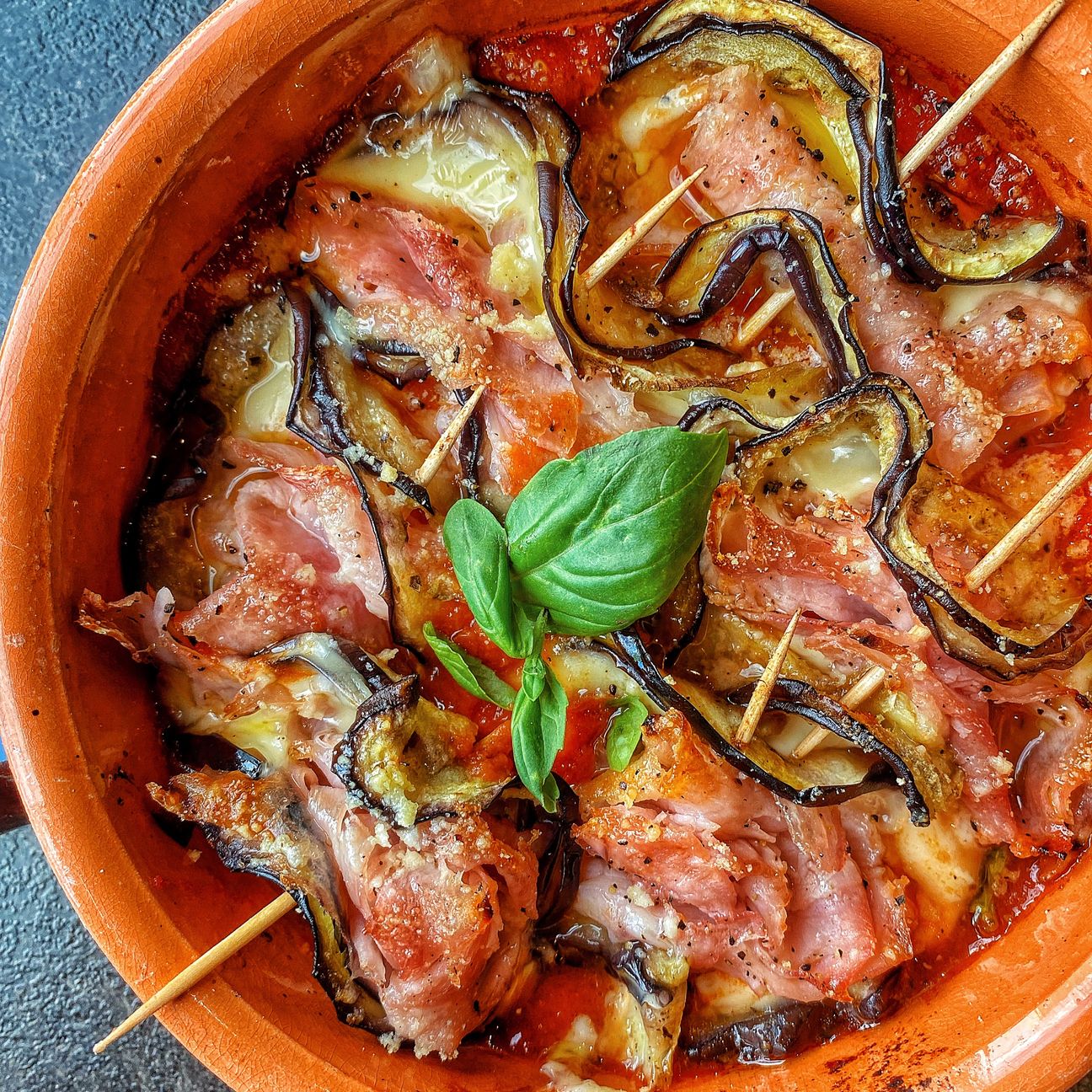 Rotolini di melanzane gratinati con sugo, ripiene di fontina e prosciutto cotto