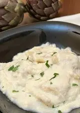 Ricetta Ravioli fatti in casa con ripieno di ricotta e carciofi, con crema di parmigiano