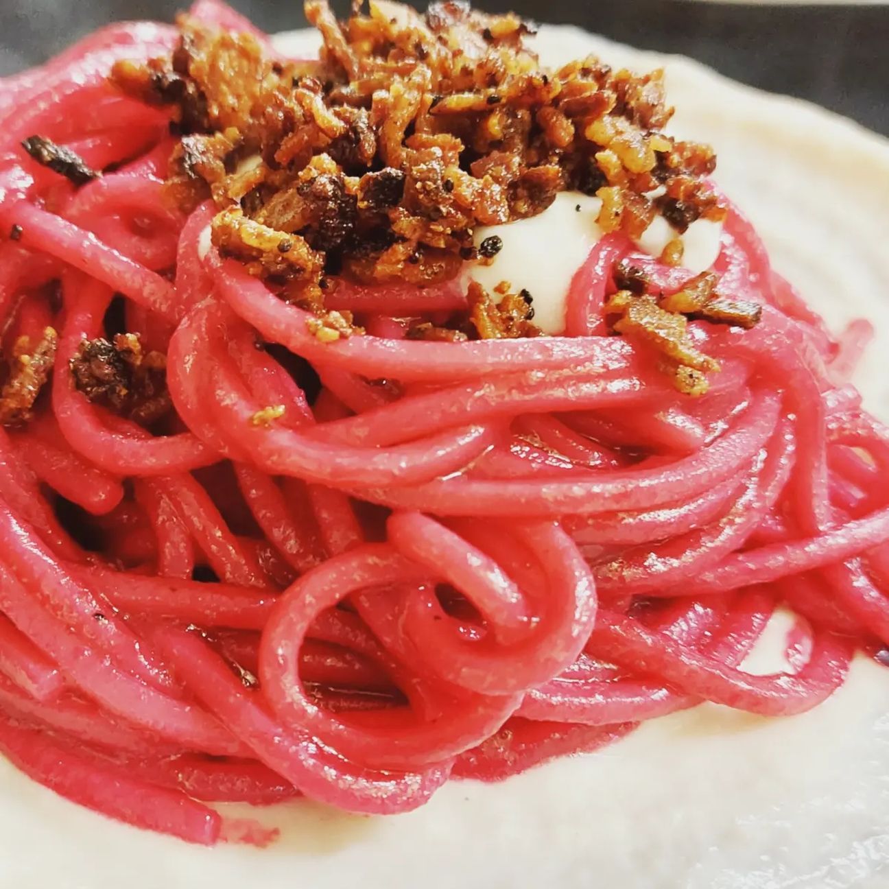 Spaghettone con crema di parmigiano, barbabietola e guanciale croccante