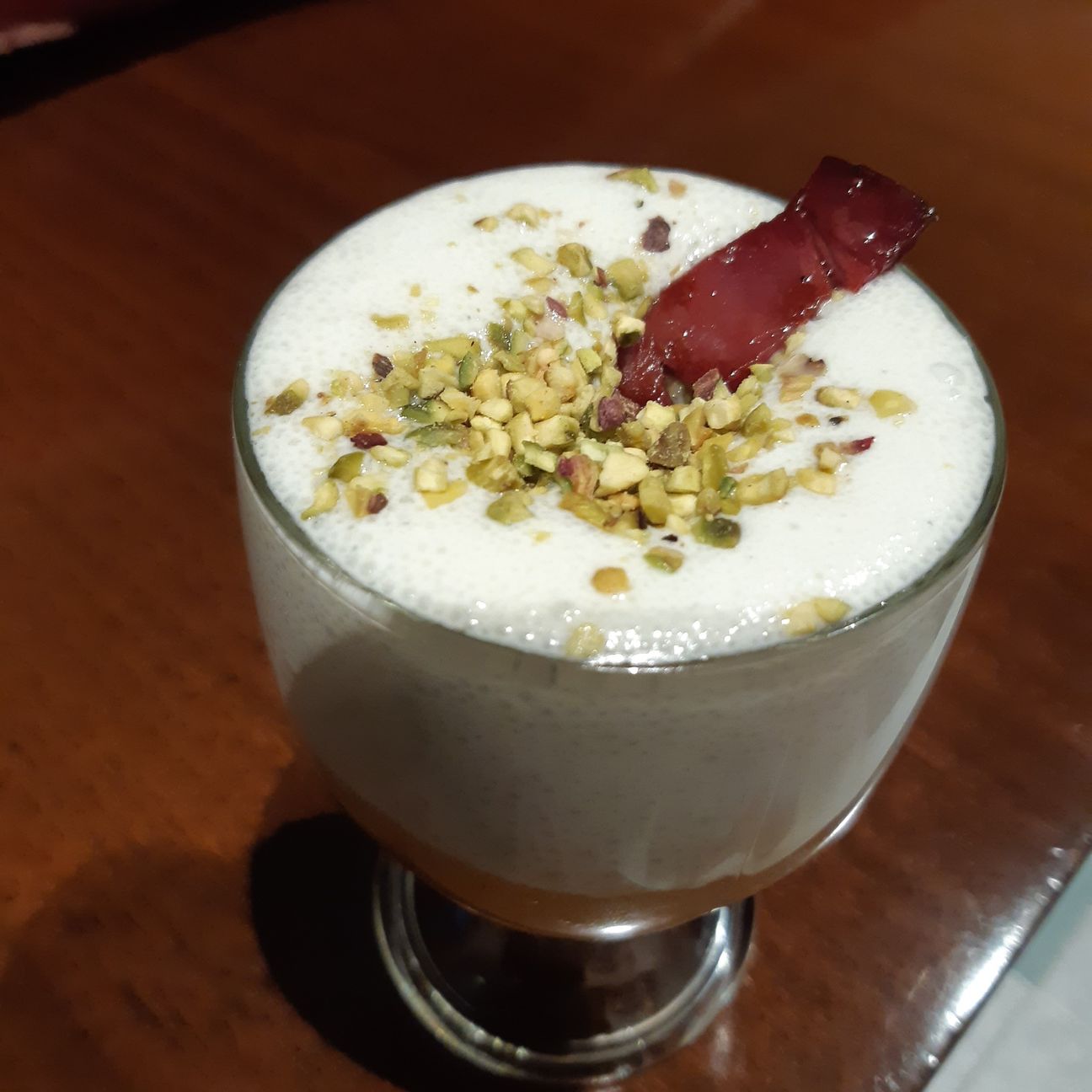 Vellutata di zucca rossa, spuma al gorgonzola, speck e granella di pistacchio